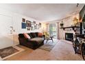 Inviting living room with a stone fireplace and sliding glass doors to balcony at 8555 Fairmount Dr # B202, Denver, CO 80247
