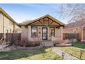 Inviting home with a manicured lawn, complemented by a brick pathway and appealing facade at 2470 Meade St, Denver, CO 80211