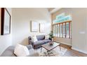 A bright and inviting living room featuring high ceilings, modern decor, and large windows with natural lighting at 11301 Vernon Way, Parker, CO 80134