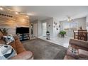 Spacious living room featuring a wooden accent wall, plush rug, and lots of natural light at 8798 Chase Dr # 4, Arvada, CO 80003