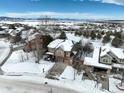 Two-story house in a snow-covered neighborhood, aerial view at 3925 Broadview Pl, Castle Rock, CO 80109