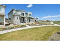 View of a modern two-story home with a well-maintained lawn and walkway in a picturesque neighborhood at 5278 Warrior St, Frederick, CO 80504
