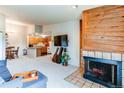Open-concept living area with fireplace, seamlessly connecting to the dining area and kitchen at 2280 S Oswego Way # 303, Aurora, CO 80014