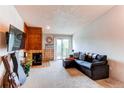 Inviting living room with a cozy fireplace, balcony access, and comfortable furnishings at 2280 S Oswego Way # 303, Aurora, CO 80014