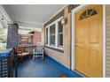 Inviting front porch featuring a rocking chair and exposed brick detail at 3415 N Vine St, Denver, CO 80205