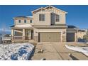 Charming two-story home with a two car garage, covered porch, and neutral siding against a blue sky at 42367 Glen Abbey Dr, Elizabeth, CO 80107