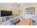Open-concept living room with carpet and a view into the kitchen featuring stainless steel appliances at 12711 Colorado Blvd # 914, Thornton, CO 80241