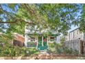 Charming front of home with a welcoming front porch and beautiful landscaping offering an inviting curb appeal at 1612 N High St, Denver, CO 80218