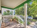 Cozy front porch with seating, plants, and view of the street at 1612 N High St, Denver, CO 80218
