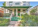 Inviting front porch with green accents and blooming flowers, perfect for relaxing outdoors and enjoying the neighborhood at 1612 N High St, Denver, CO 80218