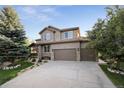Charming home with a three-car garage, manicured lawn, and beautiful curb appeal at 17490 W 67Th Ave, Arvada, CO 80007