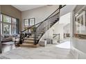 Grand foyer with staircase, elegant tile flooring, and plenty of natural light at 17490 W 67Th Ave, Arvada, CO 80007