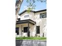 Beautiful two-story home featuring a well-manicured lawn and a striking facade with black framed windows at 1462 S Vine St, Denver, CO 80210