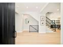 Bright foyer with light hardwood floors, modern staircase, and a clear view of the home's stylish interior at 1462 S Vine St, Denver, CO 80210