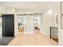 Inviting foyer with hardwood floors and glass sliding door leading to a study, offering a glimpse of the home's design at 1462 S Vine St, Denver, CO 80210