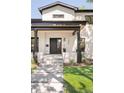Contemporary home featuring a stylish black front door, modern lighting, and well-maintained landscaping at 1462 S Vine St, Denver, CO 80210