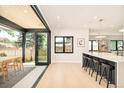 Modern open floorplan with folding doors, seamlessly connecting the dining area to the outdoor patio at 1462 S Vine St, Denver, CO 80210