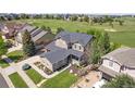 Aerial view of home in golf course community with lush green grass and scenic surroundings at 7963 S Valleyhead Way, Aurora, CO 80016