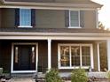 Up close, this inviting house with a front porch welcomes you with a stylish front door with glass panels at 20460 Oakbrook Ln, Parker, CO 80138