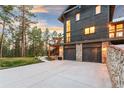 A multi-level home offers stunning views, deck, and stone-accented garages at 5090 S Perry Park, Sedalia, CO 80135