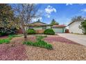 Well-maintained home featuring a two-car garage and attractive yard with trees at 1669 S Uvalda St, Aurora, CO 80012