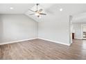 Spacious living room featuring vaulted ceilings, recessed lighting, and stylish wood-look flooring at 335 N 11Th Ave, Brighton, CO 80601