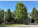 Well-maintained home featuring brick exterior, mature trees, landscaped yard, and a two car garage at 16177 E Prentice Pl, Centennial, CO 80015