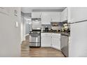 White cabinets and stainless steel appliances in this small kitchen at 63 S Sable Blvd # 16, Aurora, CO 80012
