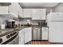 White cabinets, stainless steel appliances, and dark countertops in this galley kitchen at 63 S Sable Blvd # 16, Aurora, CO 80012