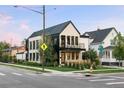 Attractive 2 story house on a corner lot with a black metal roof, a balcony, and professional landscaping at 4590 Wolff St, Denver, CO 80212