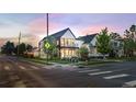 Attractive two-story house with black metal roof sits on a corner with street views and inviting landscaping at 4590 Wolff St, Denver, CO 80212