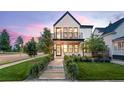Charming two-story home boasts a modern design, well-manicured lawn, and inviting walkway to the front door at 4590 Wolff St, Denver, CO 80212
