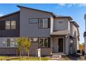 Modern two-story home with a stylish gray exterior and landscaping, showcasing its inviting curb appeal at 1443 Great Western Dr, Longmont, CO 80501