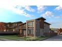 Modern home with brick and wood accents, balcony, and well-maintained lawn at 1016 24Th St, Golden, CO 80401