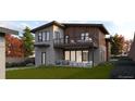 Backyard view of a two-story modern home with a balcony and outdoor seating on the ground level at 1016 24Th St, Golden, CO 80401
