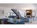 Bright, open-concept living space with fireplace and modern staircase features hardwood floors at 1016 24Th St, Golden, CO 80401