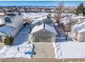 Attractive home exterior with snowy landscape at 9485 Joyce Ln, Highlands Ranch, CO 80126