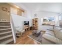 Bright living room with hardwood floors and comfortable seating at 9485 Joyce Ln, Highlands Ranch, CO 80126