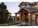 Stone porch with a covered entrance and landscaping at 1365 Gentry Pl, Castle Rock, CO 80104