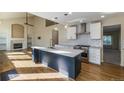 Bright, open kitchen featuring a center island, stainless steel appliances, and hardwood floors at 15498 E Dorado Pl, Centennial, CO 80015