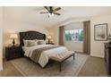 Comfortable main bedroom with a large window, upholstered bed, and neutral decor at 15498 E Dorado Pl, Centennial, CO 80015