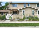 Inviting townhome exterior with a cozy courtyard, metal planters, and white picket fence at 8422 Everett Way # C, Arvada, CO 80005