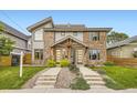 Modern townhomes boasting mixed brick and siding exteriors, complemented by professionally landscaped front yards and welcoming walkways at 2442 S Bannock St, Denver, CO 80223