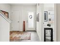 Bright entryway features tile flooring, a white door with a wreath, and modern decor creating a welcoming space at 3414 W 18Th Ave, Denver, CO 80204