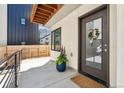 Charming townhouse entryway featuring a glass door, flower pot, and wooden accents at 3414 W 18Th Ave, Denver, CO 80204