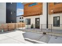Modern townhome featuring wood accents, white walls, and black trim on the windows at 3414 W 18Th Ave, Denver, CO 80204