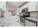 Stainless steel appliances and granite countertops at 3184 S Heather Gardens Way # 403, Aurora, CO 80014