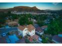 An aerial view showcasing the home with a deck, and solar panels at 420 Sunshine Pkwy, Golden, CO 80403