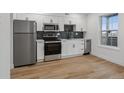 Modern kitchen with stainless steel appliances and white cabinets at 9120 E Girard Ave # 12, Denver, CO 80231
