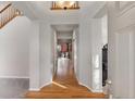 Bright entryway with hardwood floors and modern lighting at 2414 Winding Dr, Longmont, CO 80504